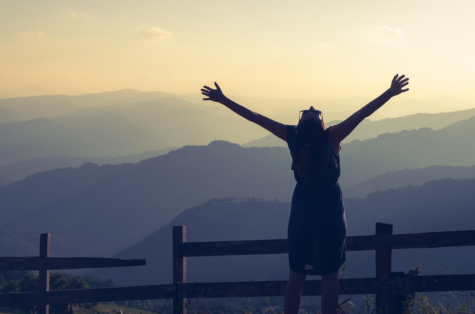 Woman with glasses spreading her arms