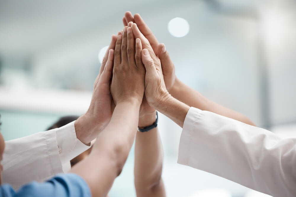 High five, teamwork and doctors hands in collaboration for mission